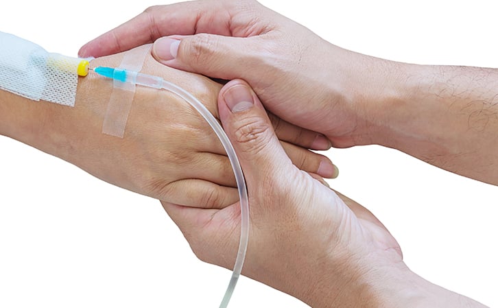 Holding-hands-with-patient-using-IV-drip