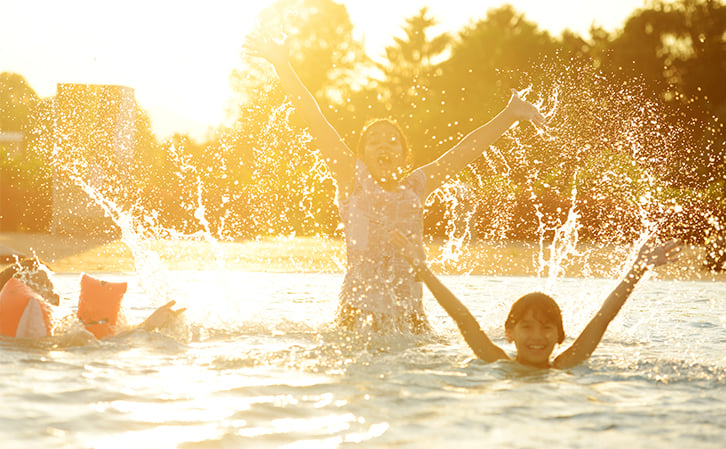 people bathing in warm water