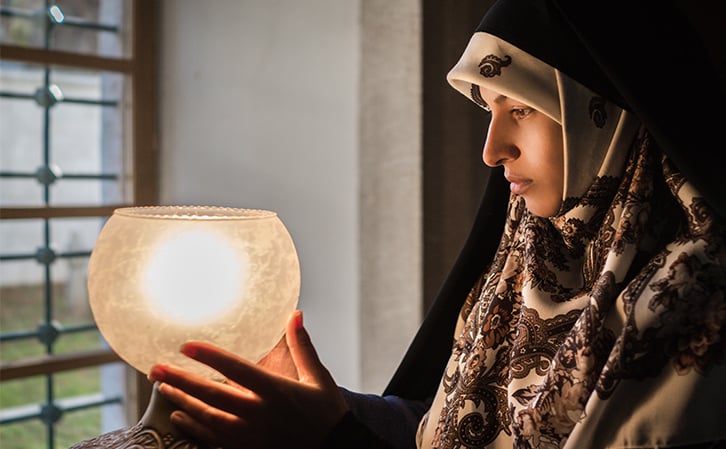 woman holding a lamp